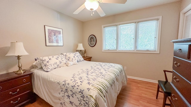 bedroom with baseboards, wood finished floors, and a ceiling fan