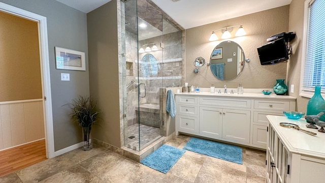 bathroom featuring vanity and a shower stall