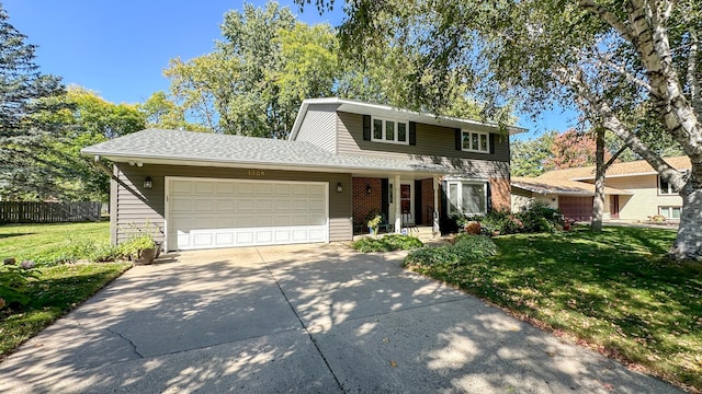 traditional-style home with a front yard, an attached garage, fence, and driveway