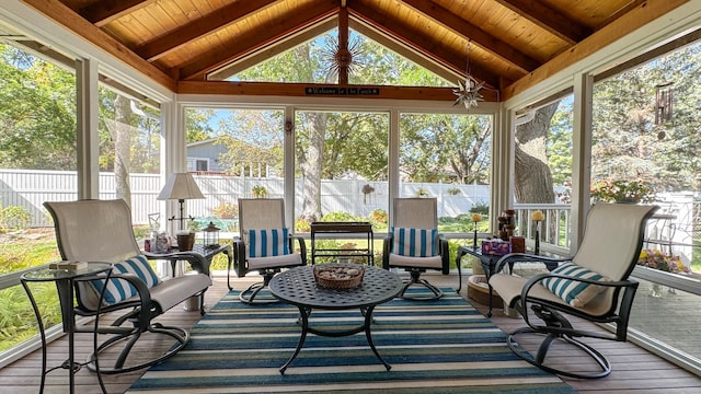 sunroom with a healthy amount of sunlight, wooden ceiling, and vaulted ceiling with beams