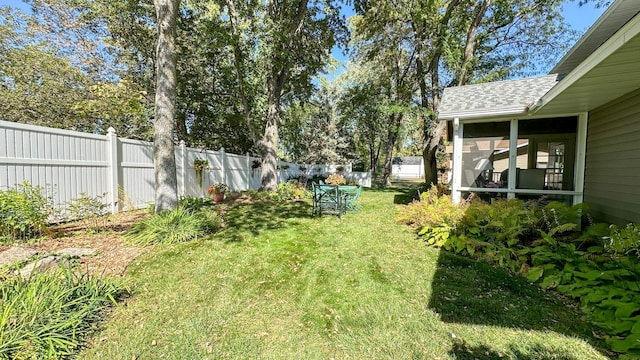 view of yard with fence private yard and a sunroom