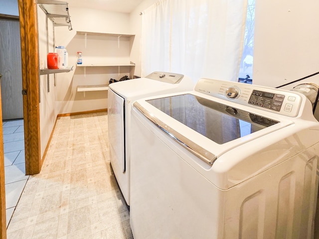 laundry area with light floors and washing machine and dryer