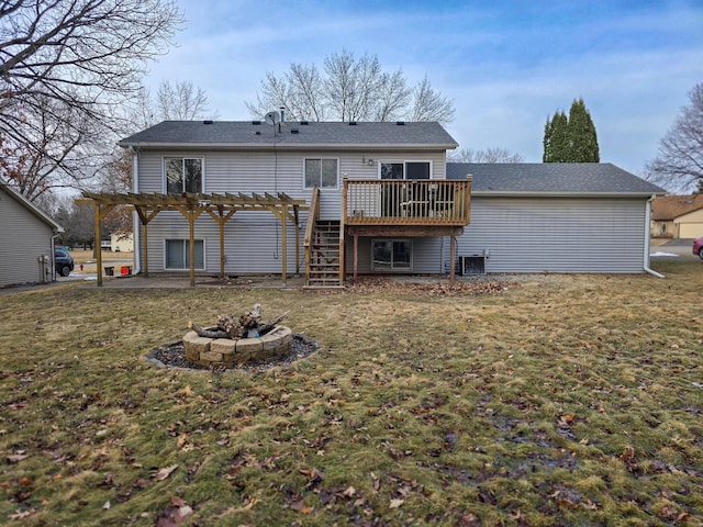 rear view of property with a pergola, an outdoor fire pit, a yard, cooling unit, and a wooden deck