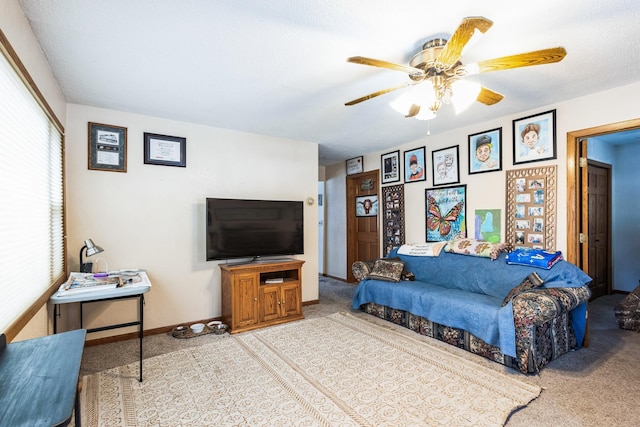 living room with ceiling fan and baseboards