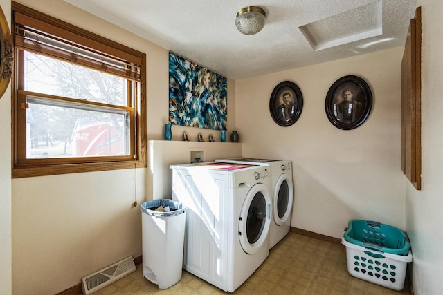 laundry area with visible vents, washer and clothes dryer, light floors, attic access, and laundry area