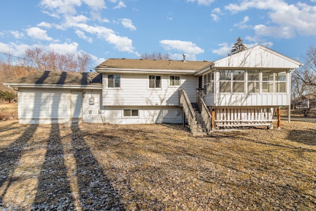 back of property featuring stairway and a sunroom