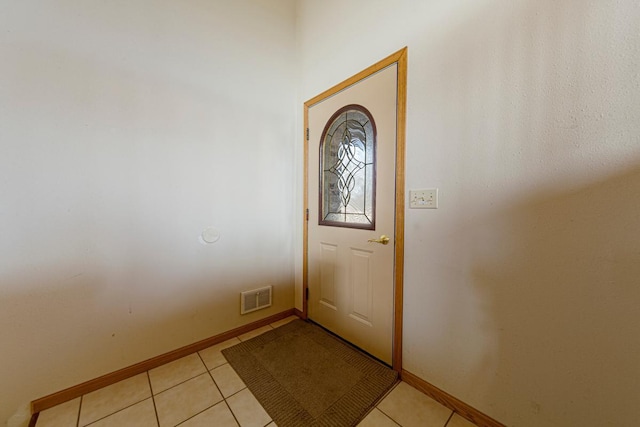 entrance foyer with light tile patterned floors, visible vents, and baseboards