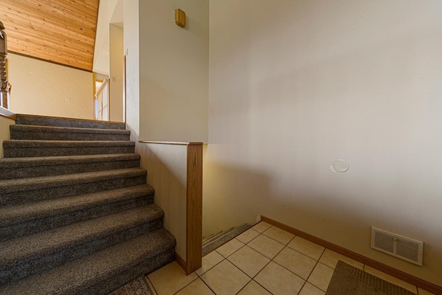 stairs featuring visible vents, baseboards, and tile patterned flooring