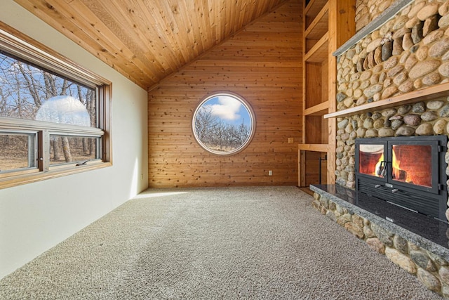 unfurnished living room with wood walls, wooden ceiling, lofted ceiling, and carpet floors