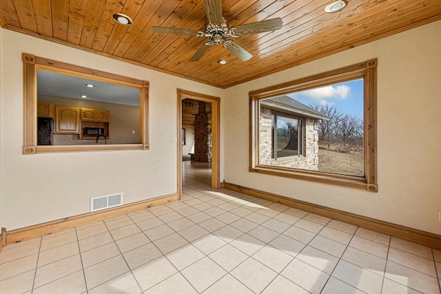 spare room featuring light tile patterned flooring, visible vents, wooden ceiling, and baseboards