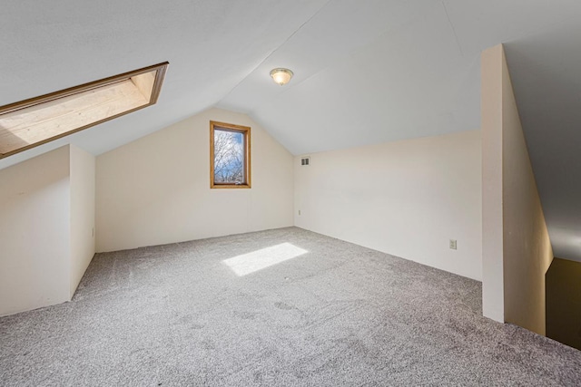 bonus room with visible vents, carpet, and vaulted ceiling