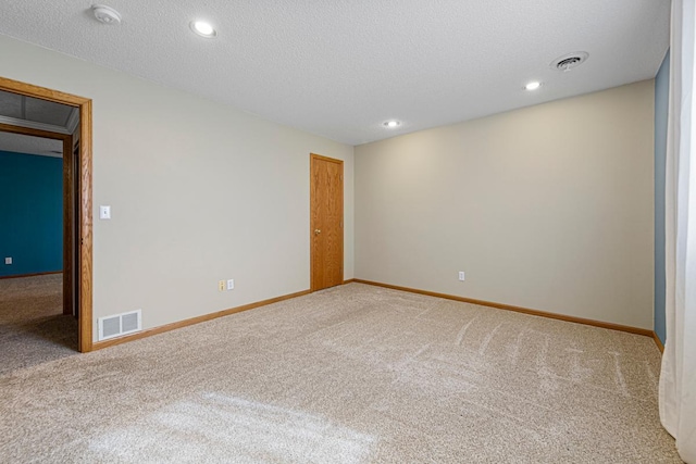 carpeted empty room featuring recessed lighting, baseboards, visible vents, and a textured ceiling