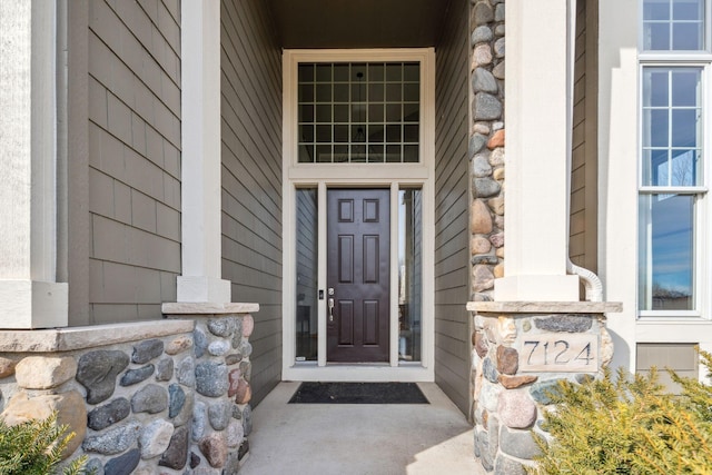 entrance to property with stone siding