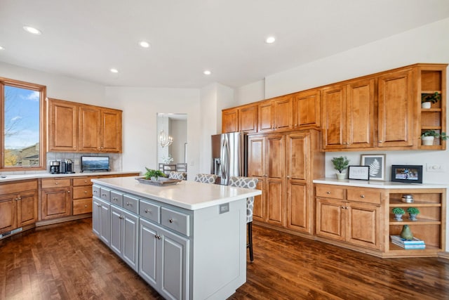 kitchen featuring open shelves, gray cabinetry, light countertops, dark wood-type flooring, and stainless steel refrigerator with ice dispenser