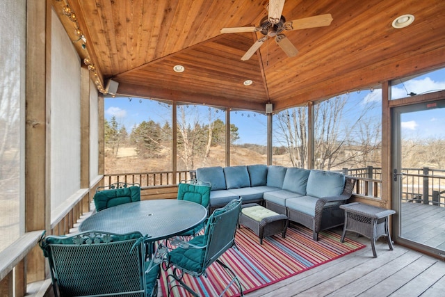 sunroom with wood ceiling, a healthy amount of sunlight, ceiling fan, and vaulted ceiling