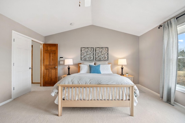 carpeted bedroom featuring baseboards and lofted ceiling