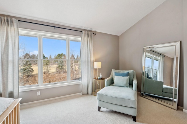 sitting room featuring vaulted ceiling, carpet flooring, and baseboards