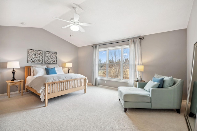 bedroom featuring light colored carpet, ceiling fan, baseboards, and vaulted ceiling