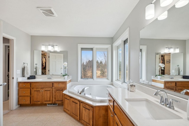 bathroom featuring tile patterned floors, visible vents, and a sink