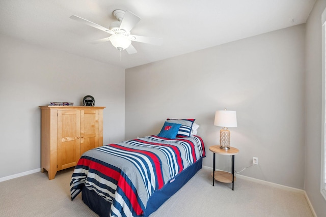 bedroom featuring light colored carpet, baseboards, and ceiling fan