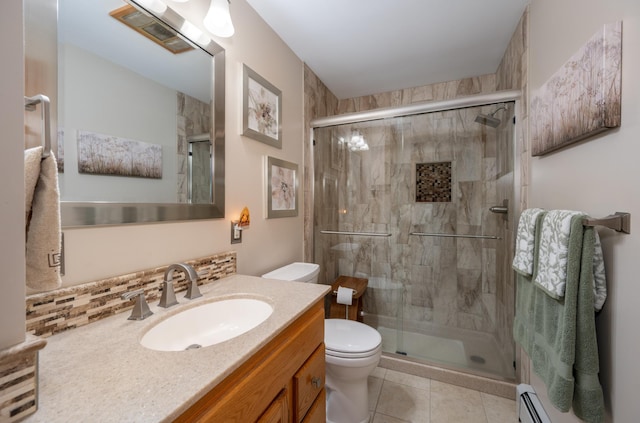 full bathroom featuring vanity, a stall shower, tile patterned floors, toilet, and baseboard heating