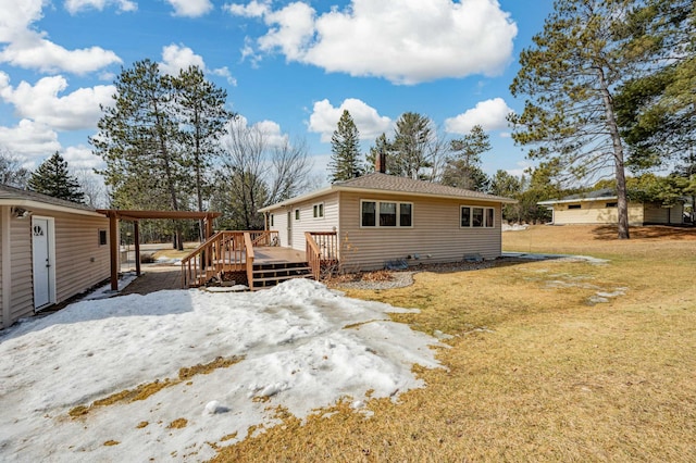 back of property featuring a yard and a deck