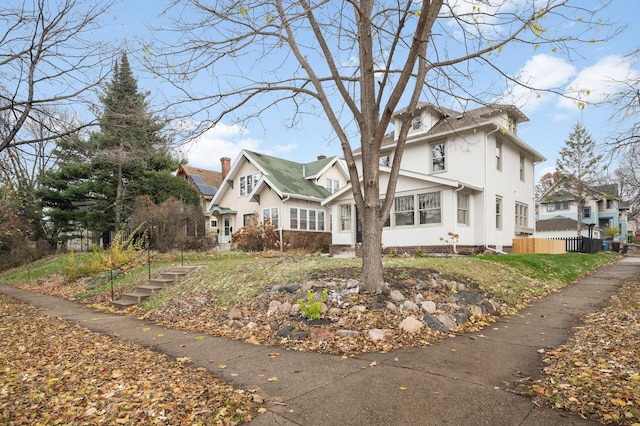 view of front of property featuring stucco siding and fence