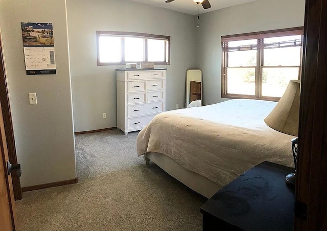 carpeted bedroom with multiple windows and baseboards