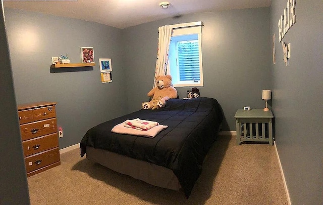 bedroom with baseboards and carpet floors