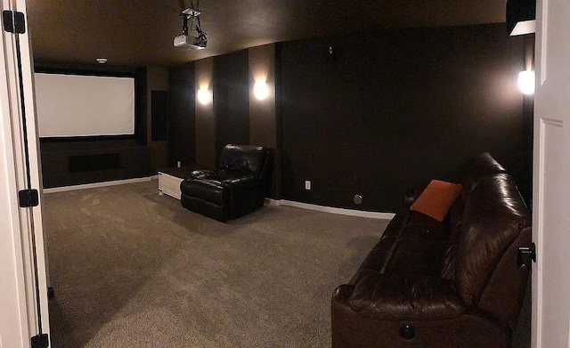 carpeted cinema room with baseboards