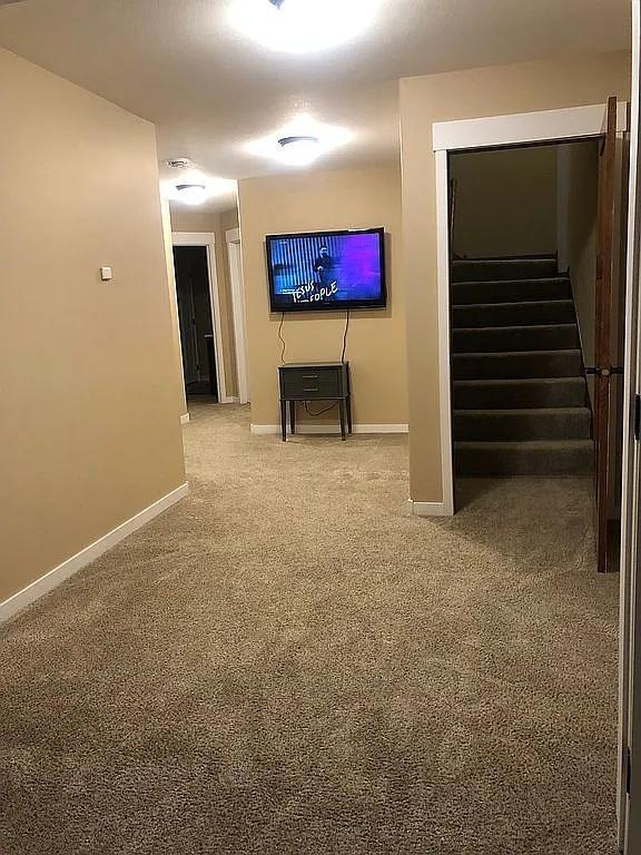 interior space featuring stairs and baseboards