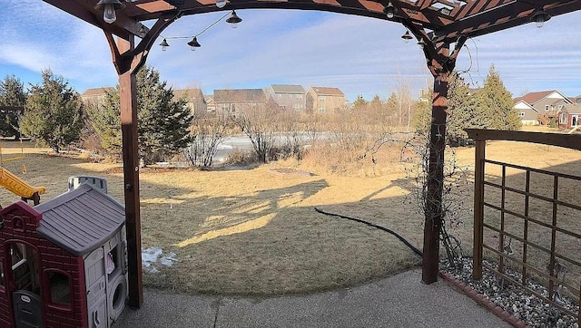 view of yard featuring a pergola and fence