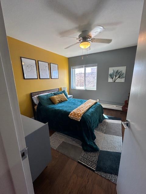 bedroom with wood finished floors and a ceiling fan