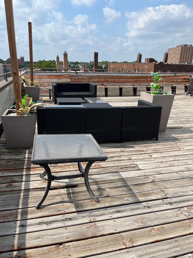 wooden deck featuring outdoor lounge area and a city view