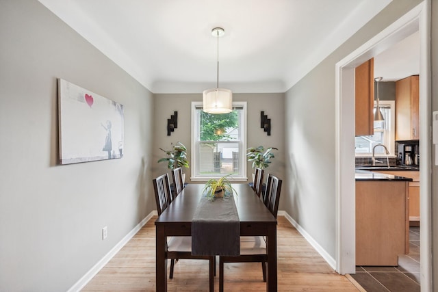 dining room with light wood-type flooring and baseboards