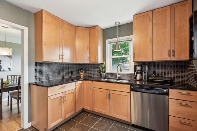 kitchen featuring decorative backsplash, dishwasher, dark tile patterned flooring, and a sink