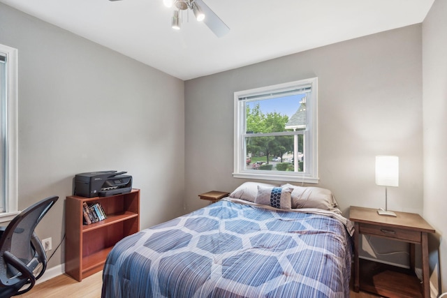 bedroom with light wood-type flooring and a ceiling fan