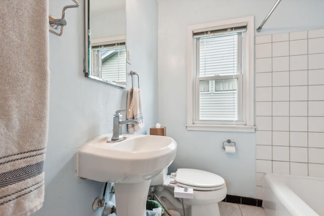 bathroom featuring tile patterned flooring, shower / bathing tub combination, and toilet