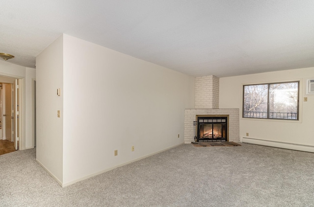 unfurnished living room featuring carpet flooring, a fireplace, a baseboard heating unit, and baseboards