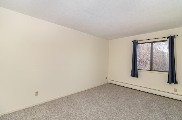 empty room featuring baseboards, baseboard heating, carpet flooring, and a textured ceiling