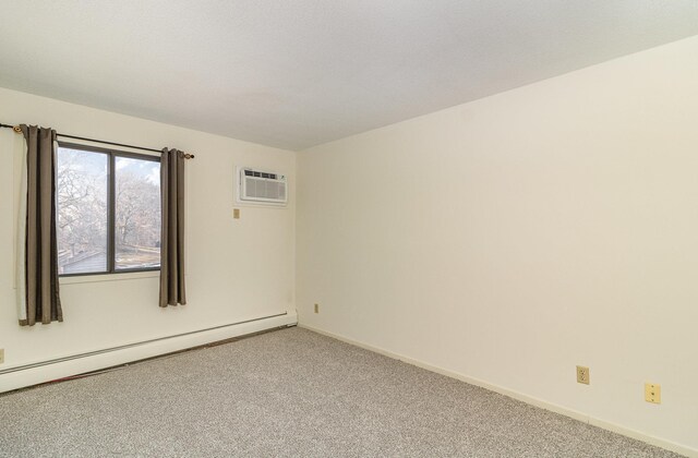 spare room with an AC wall unit, a baseboard heating unit, baseboards, and carpet floors