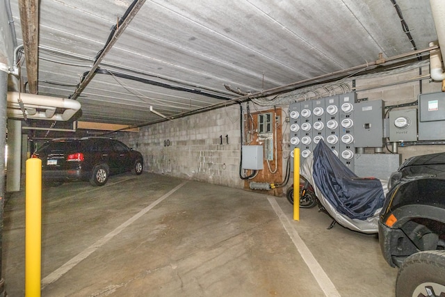 parking garage with electric panel and concrete block wall