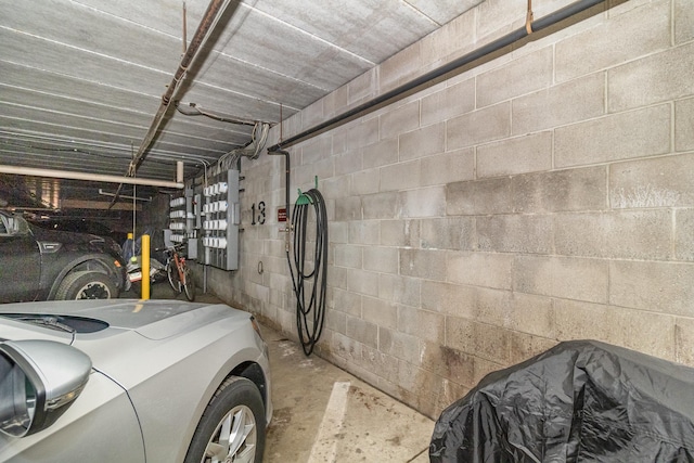 garage featuring washer / dryer and concrete block wall