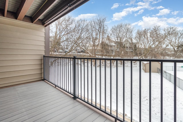 view of snow covered back of property