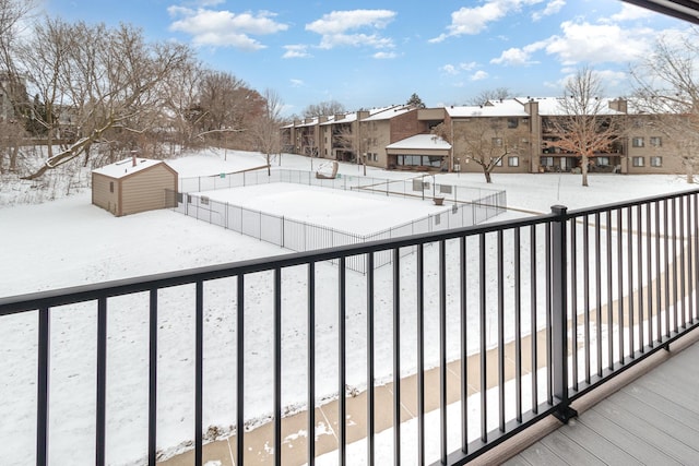 exterior space featuring a storage unit, a residential view, an outdoor structure, and fence