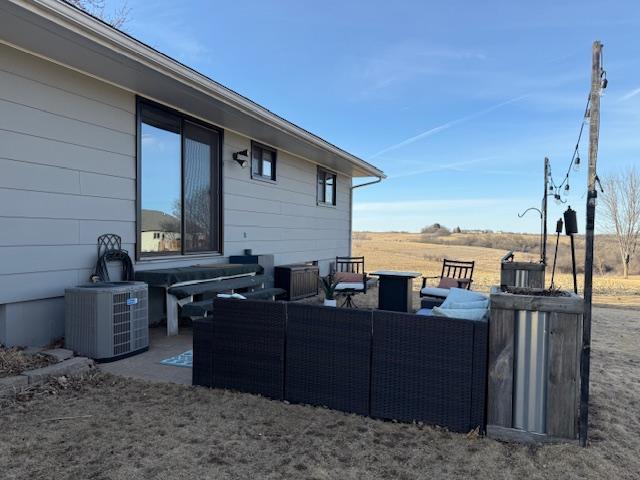 exterior space featuring cooling unit and an outdoor hangout area