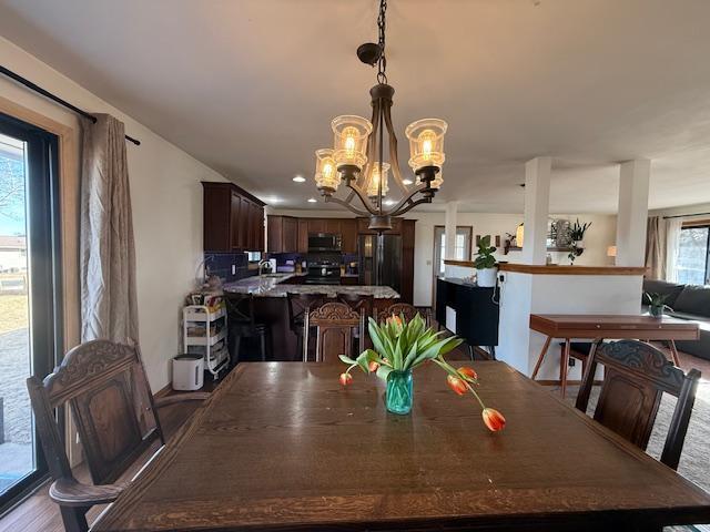 dining area with an inviting chandelier