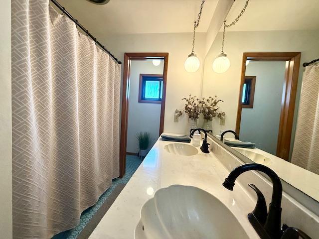 bathroom with double vanity and a sink