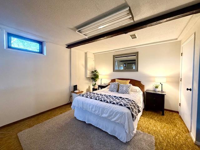 bedroom featuring visible vents and a textured ceiling