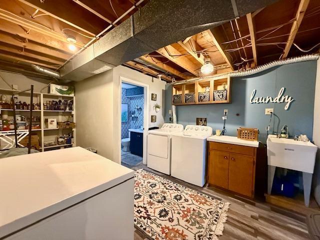 laundry area featuring cabinet space, separate washer and dryer, and light wood finished floors